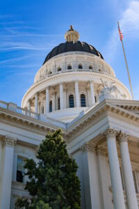 Low angle view of the historical California State Capitol Building in Sacramento against blue sky.